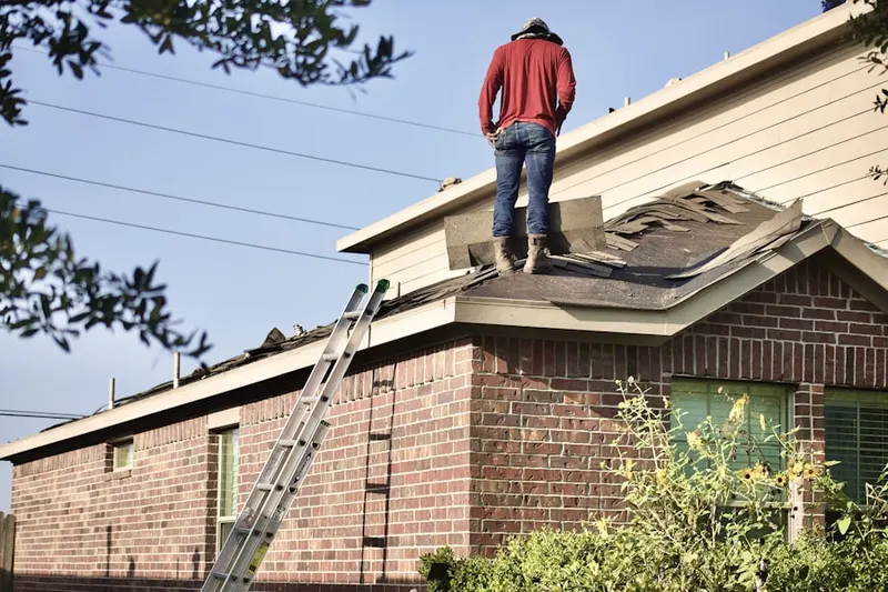 Professional roofer working on a residential roof in Livestock Event Center